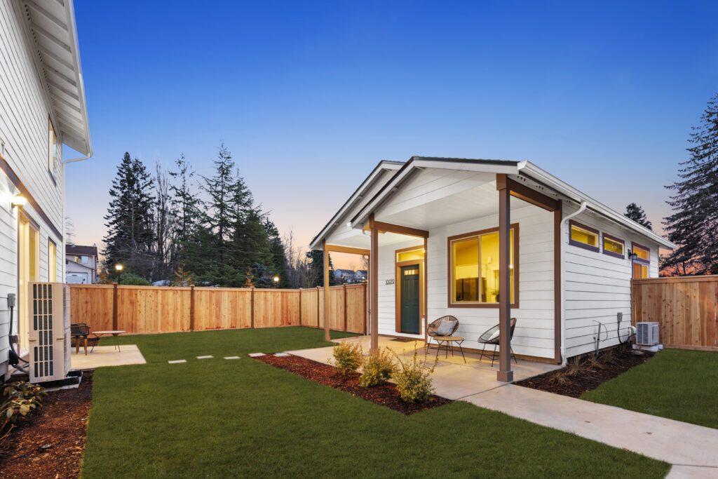 White exterior of a newly built accessory dwelling unit with landscaped yard