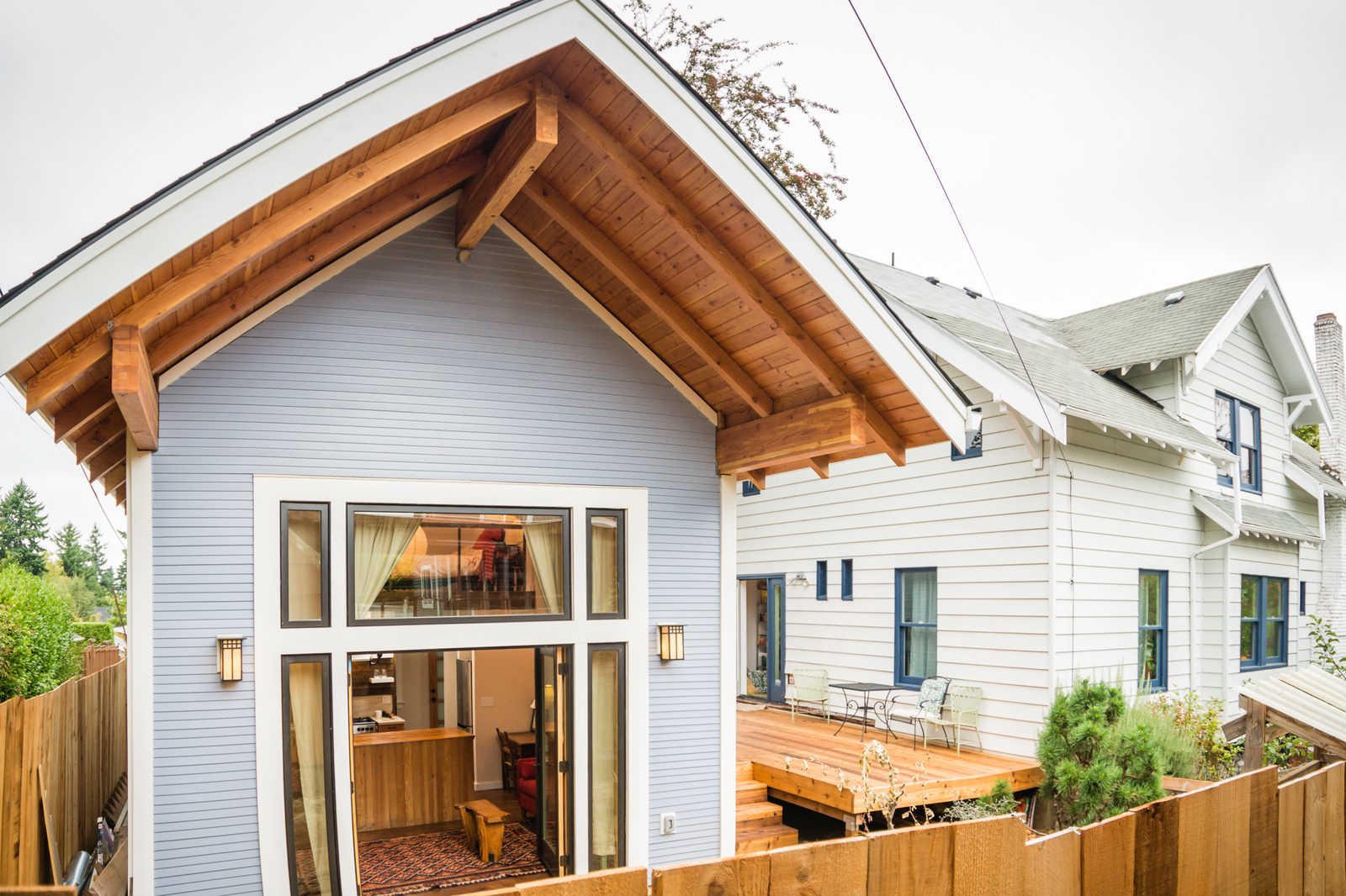 Modern backyard accessory dwelling unit with blue siding and wood accents