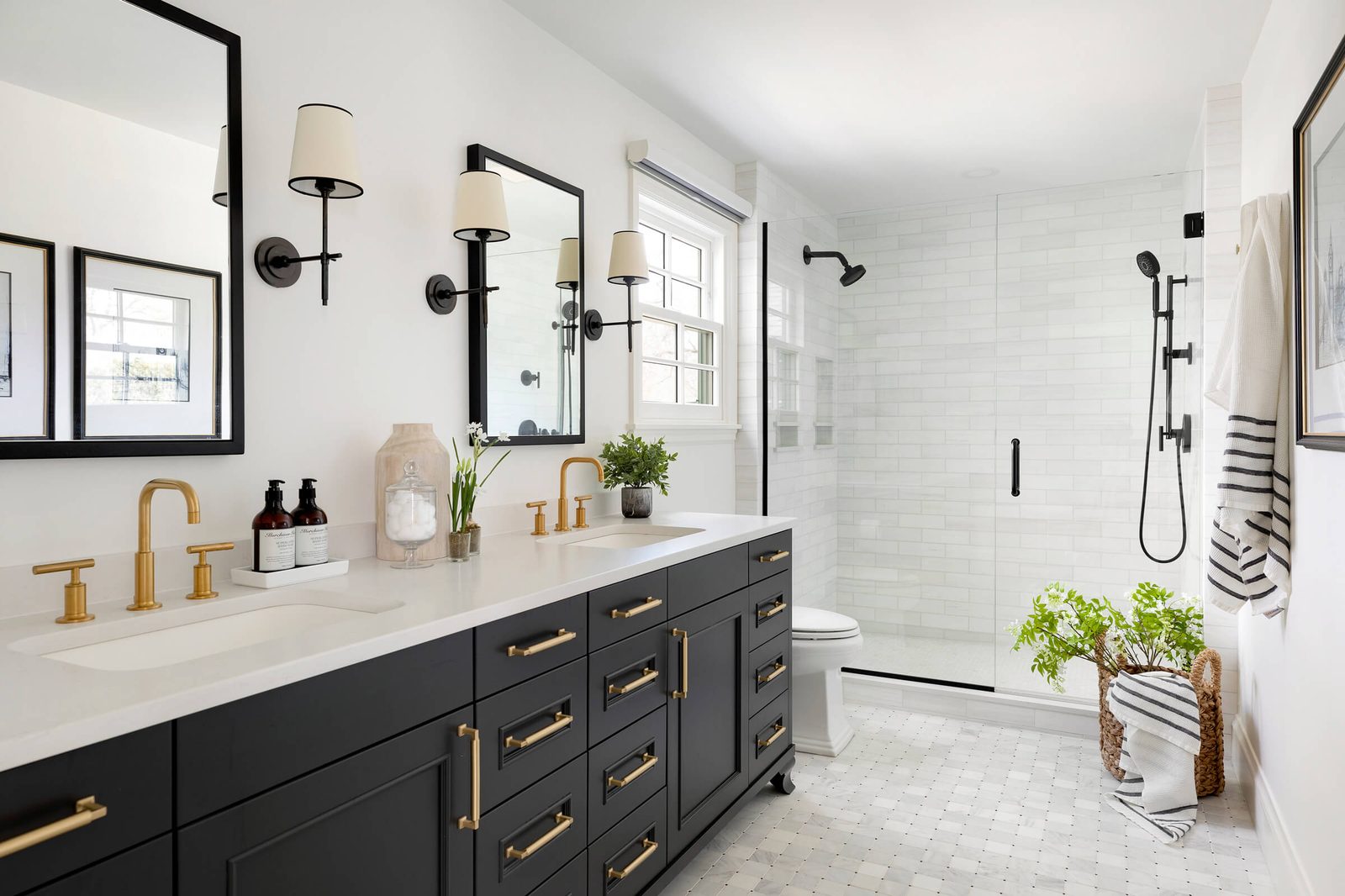 Luxury bathroom renovation featuring a freestanding tub and dark vanity