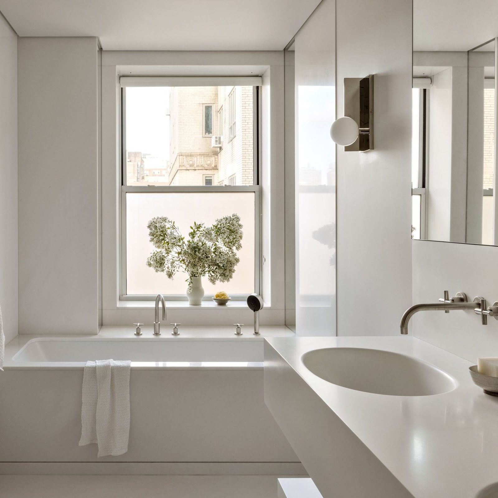 Minimalist bathroom remodel with a built-in tub and clean white aesthetic