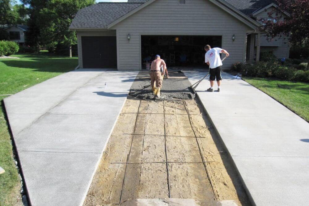 Freshly installed residential concrete driveway with expansion joints