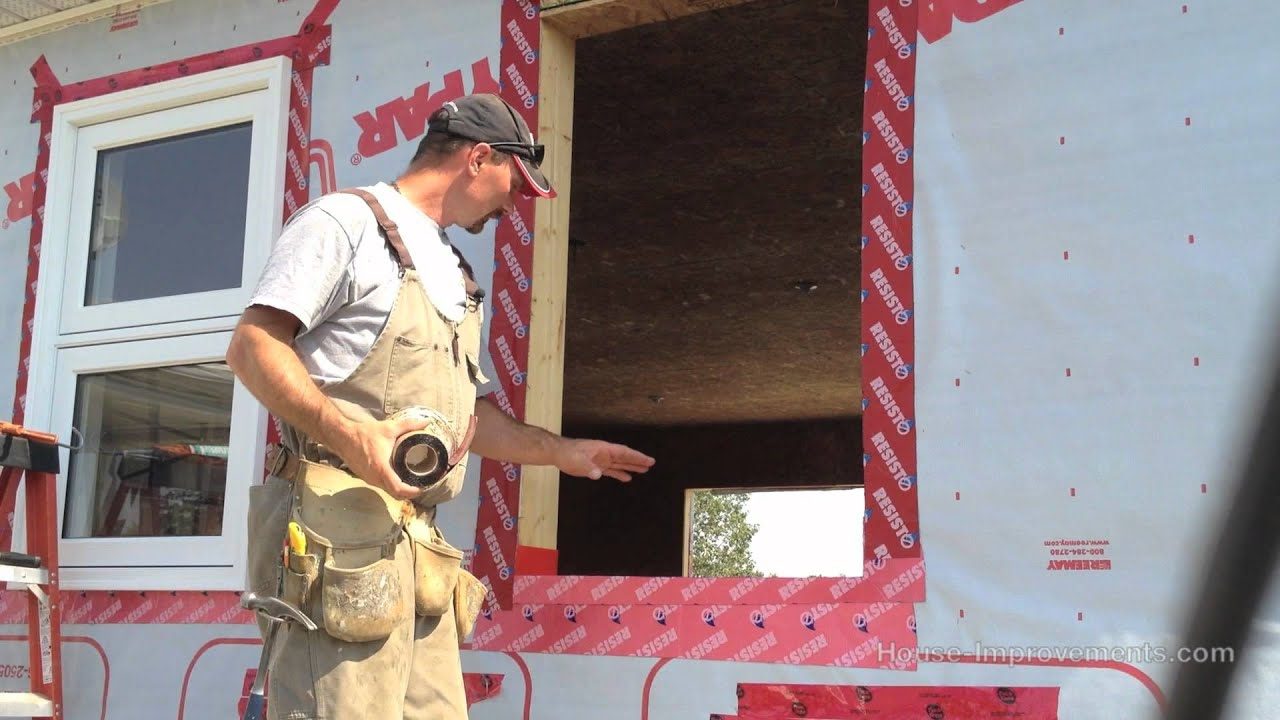 Contractor installing a new window frame during a residential window installation project