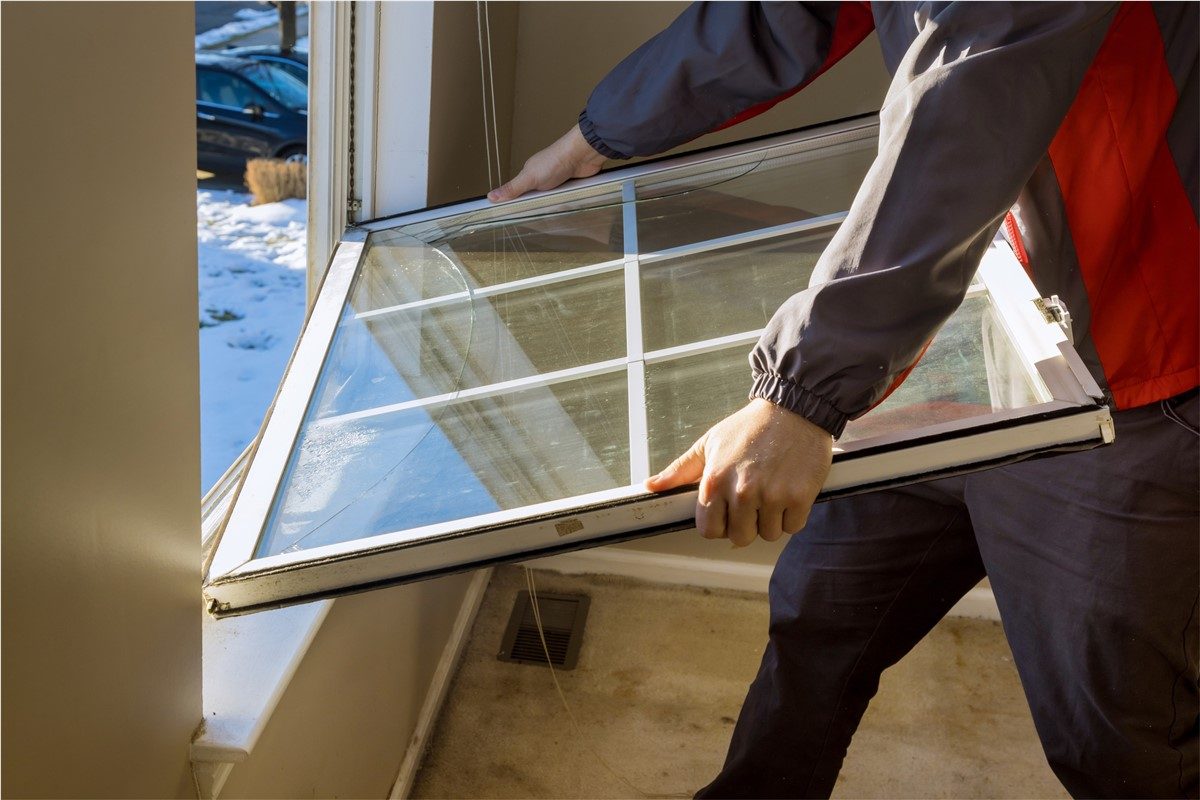 Installer checking the alignment of a newly fitted replacement window