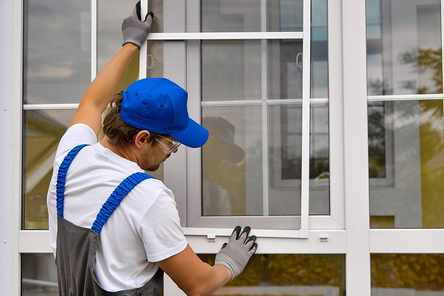 Contractor applying sealant around a newly installed replacement window