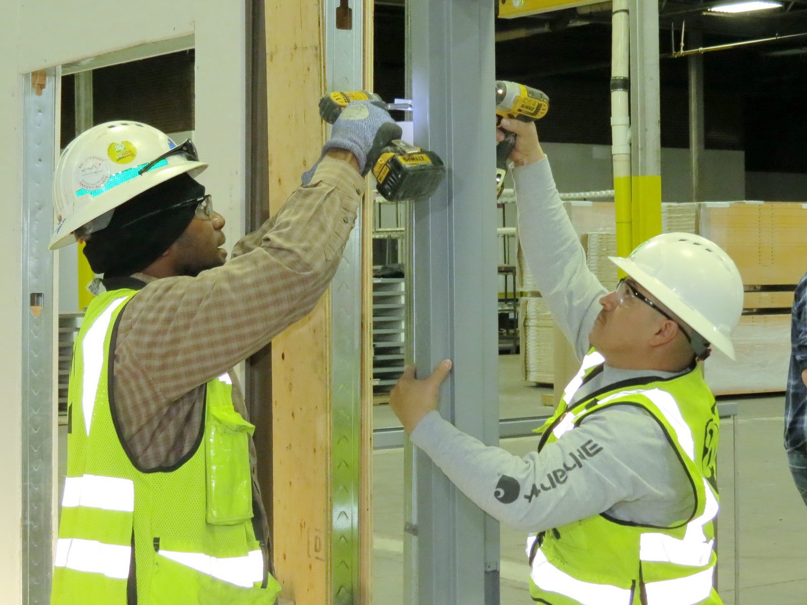 Workers installing a large commercial-style entry door system
