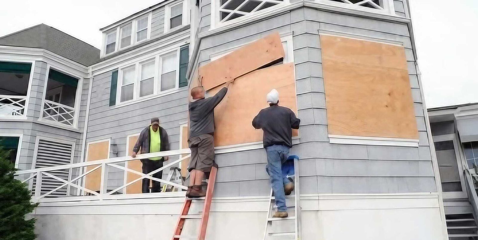 Emergency board-up services securing a residential property with plywood over windows
