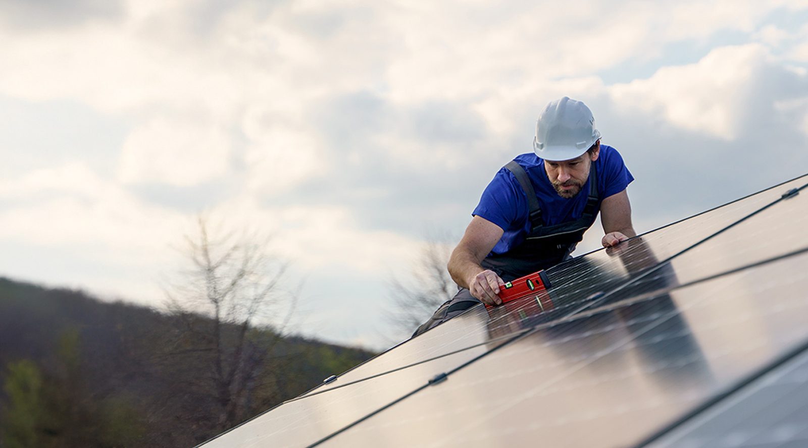 Workers installing solar panels on a residential roof for a solar-ready home