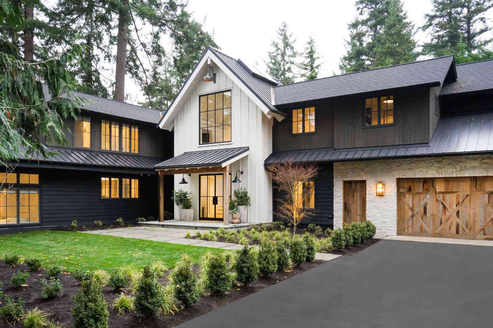 Freshly painted modern farmhouse exterior with dark siding and white trim