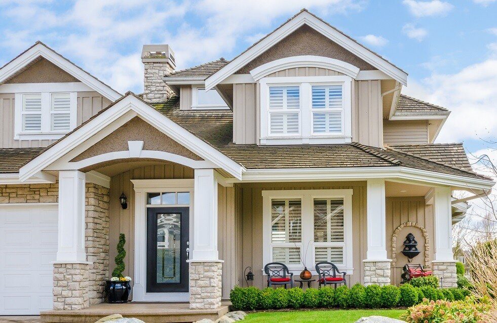 Close-up of a freshly painted residential home exterior with gray siding