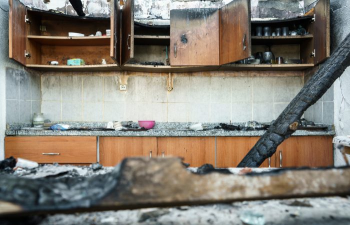 Severe fire and smoke damage in a residential kitchen before professional restoration