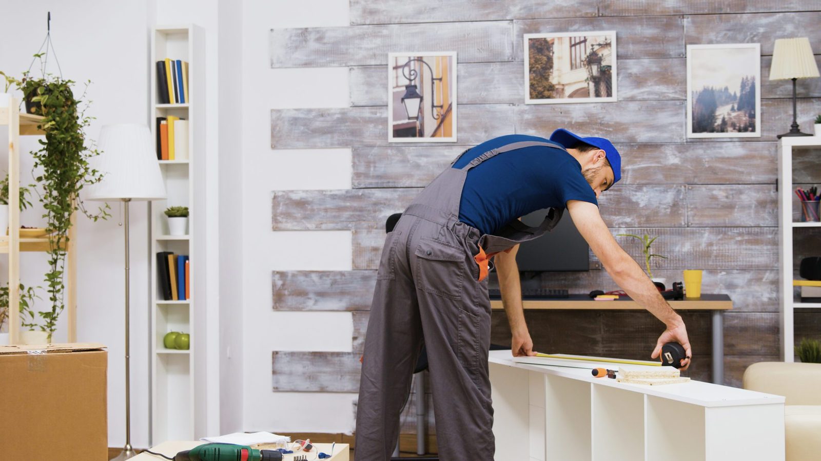 Contractors preparing kitchen walls for new cabinets during general remodeling
