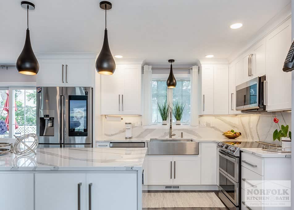 Modern kitchen remodeling featuring white shaker cabinets and quartz countertops