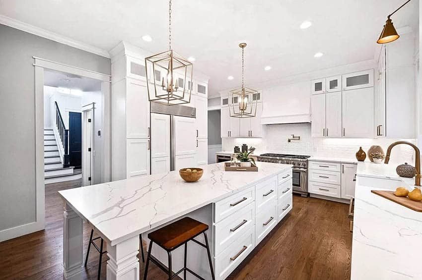 Bright remodeled kitchen with white shaker cabinets, quartz countertops, and a large island
