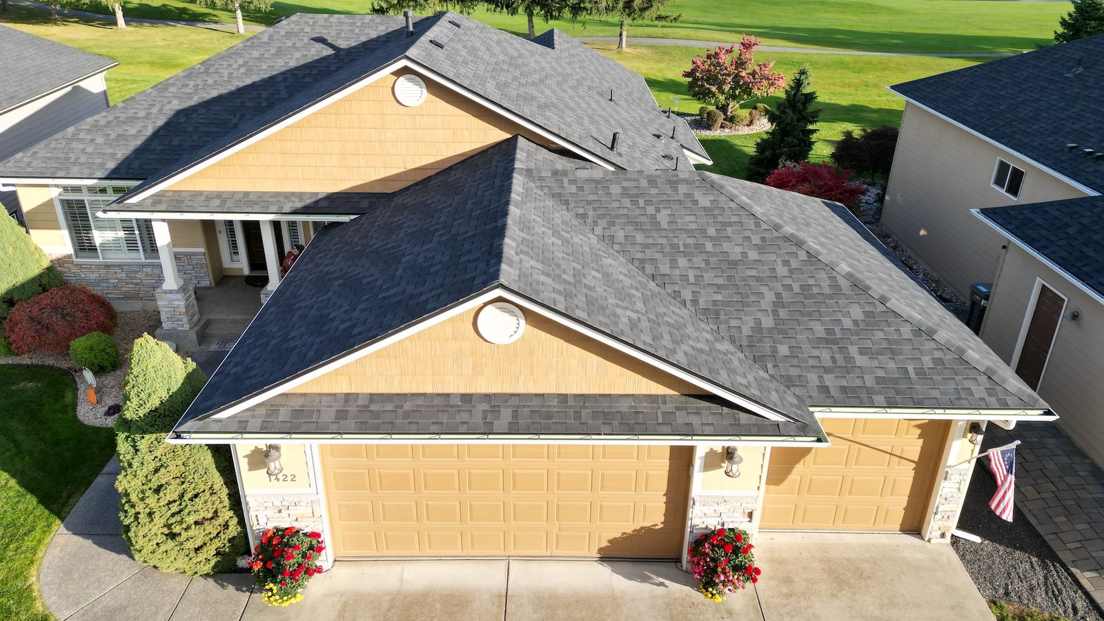 Aerial view of a completed residential roof replacement with architectural shingles